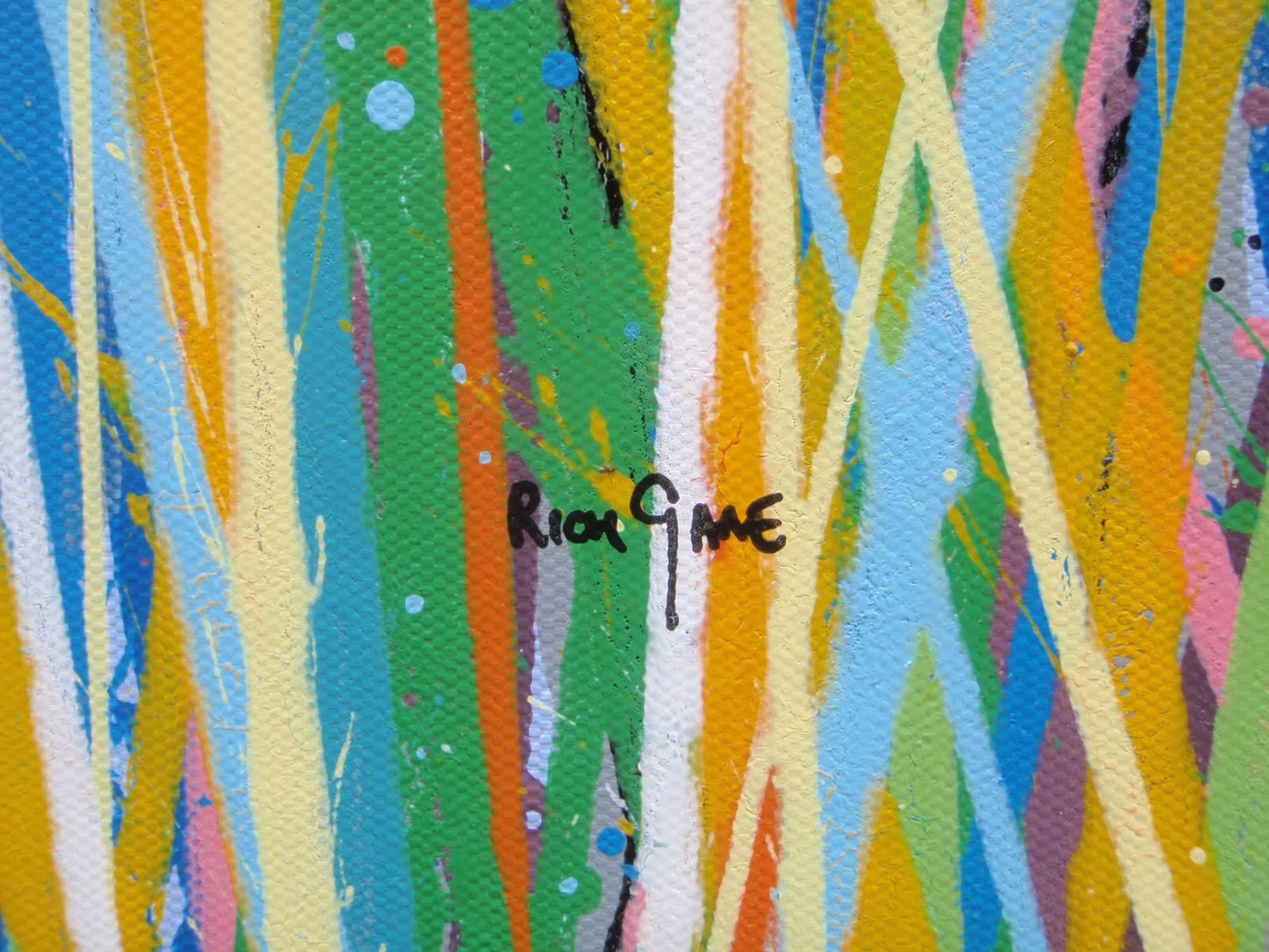 Colourful abstract art with a signature in the centre - detail
