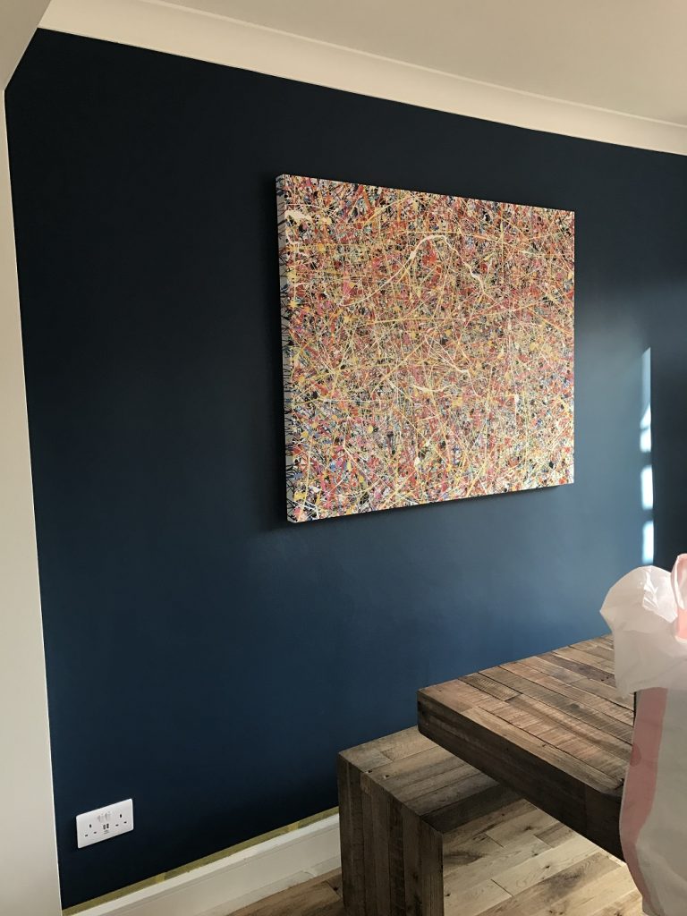 Customer photo showing my large drip painting now on display on their wall which has been painted black