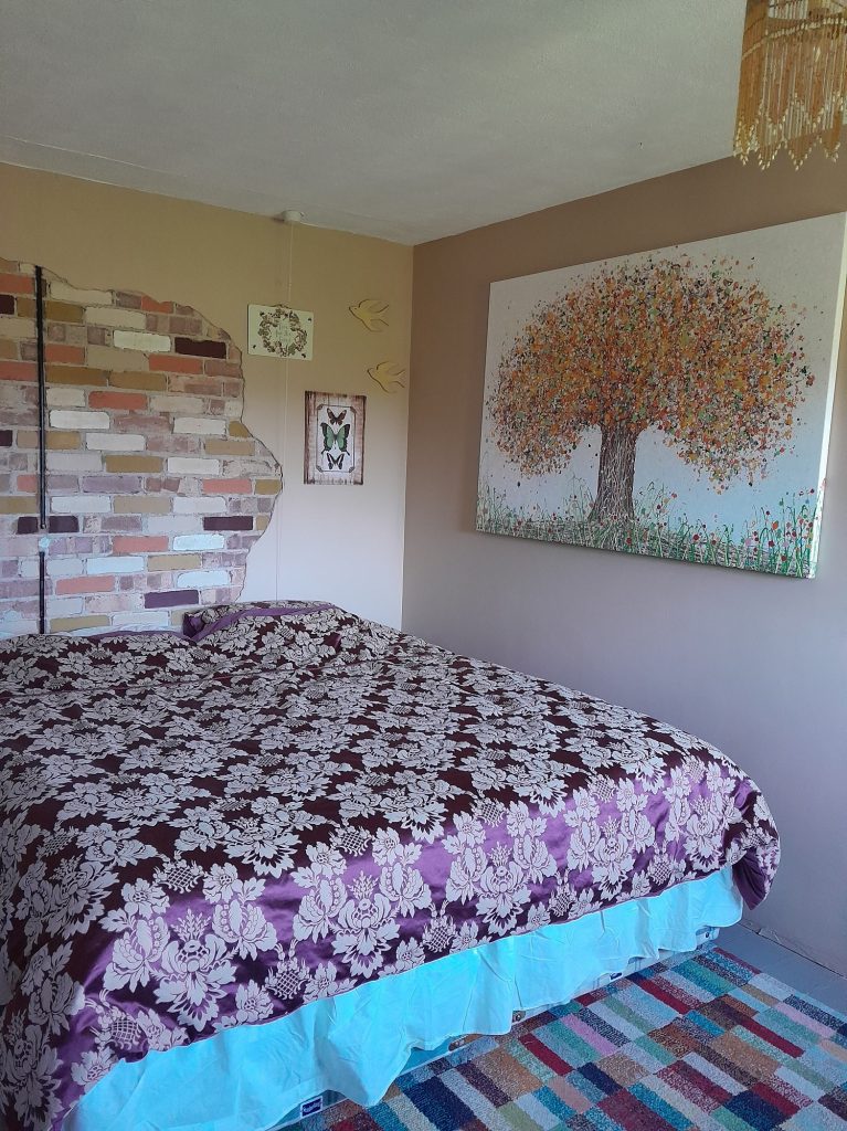 Photo sent to me by my customer showing one of my large modern art tree paintings now on display in her home