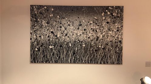 Black and white modern art flower meadow painting on a very large canvas on display in customer's home