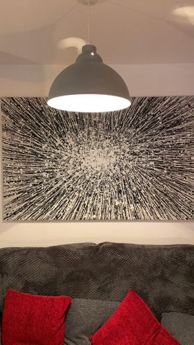 Black and white abstract star painting on very large canvas on display in customer's home