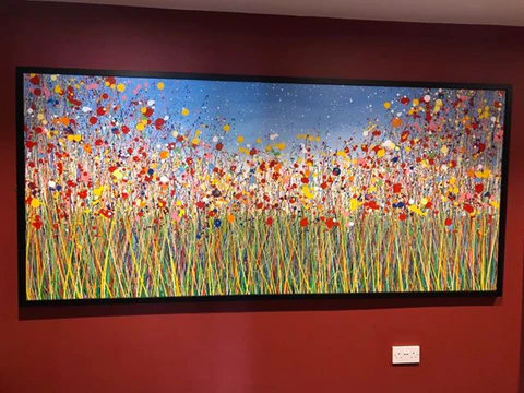 Customer showcase photo of my very wide flower painting with an external black picture frame around it - front view