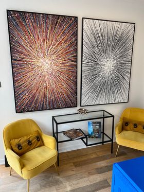 Customer showcase photo of two of my very large original star paintings that are now on display in his shop