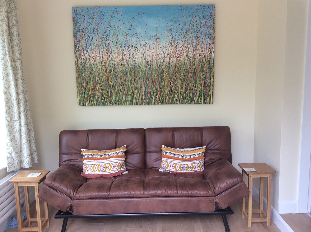 Big grass meadow painting with blue sky hanging in my customer's house