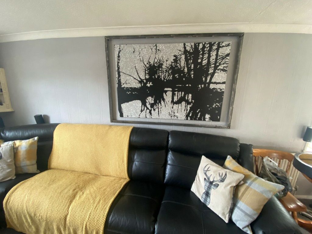 Hand painted black and white semi abstract landscape painting on display in my customer's home