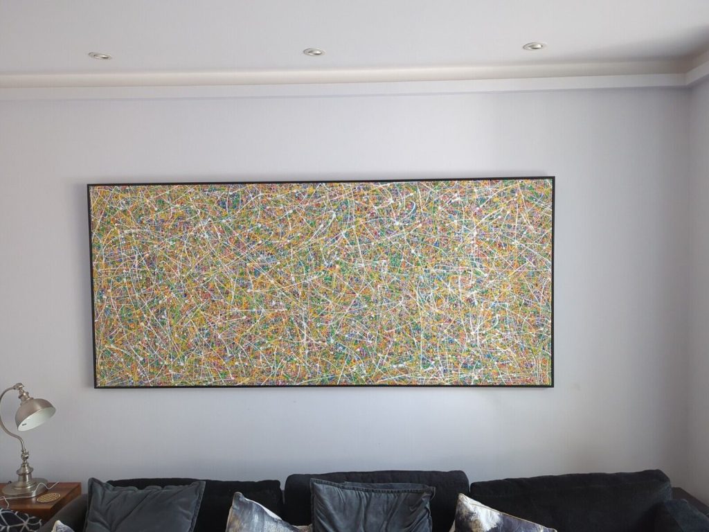 Customer showcase photo of my massive 244 cm by 112 cm original colourful drip painting on display in his home