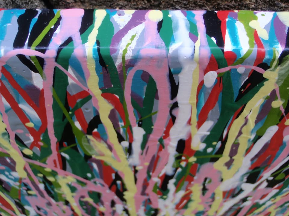 Abstract art with multicoloured vertical brush strokes on a white background - detail