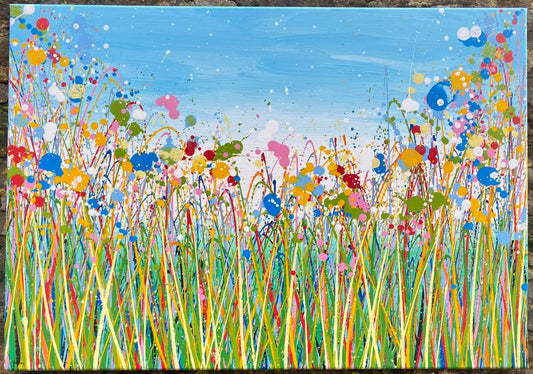 Colourful abstract painting of flowers and grass with a blue sky background, on a 100 by 70 cm canvas - full view