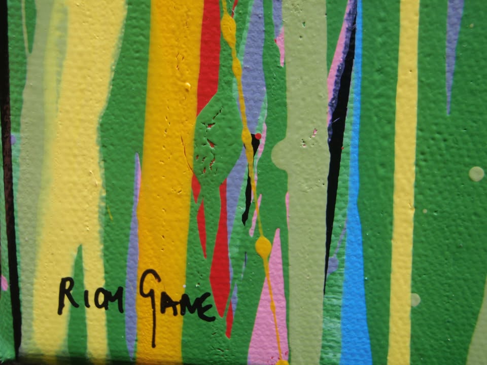 A colourful abstract painting of a grassy field with tall green, yellow, and red strokes, dotted with red, blue, orange, and pink flowers, beneath a light blue sky with white paint splatter. Hand-painted on to a large 100 by 70 cm canvas - detail