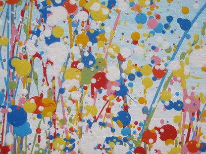A colourful abstract painting of a grassy field with tall green, yellow, and red strokes, dotted with red, blue, orange, and pink flowers, beneath a light blue sky with white paint splatter. Hand-painted on to a large 100 by 70 cm canvas - detail
