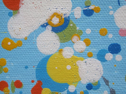 A colourful abstract painting of a grassy field with tall green, yellow, and red strokes, dotted with red, blue, orange, and pink flowers, beneath a light blue sky with white paint splatter. Hand-painted on to a large 100 by 70 cm canvas - detail