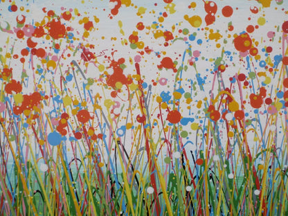 A colourful abstract painting of a grassy field with splattered flowers in orange, yellow, blue, and white against a light blue sky, hand-painted on to a large framed 100 by 70 cm canvas - detail