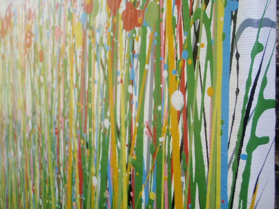 Abstract floral field painting with green grass-like strokes and many red, yellow, blue, and pink flower-like splatters on a white background - detail