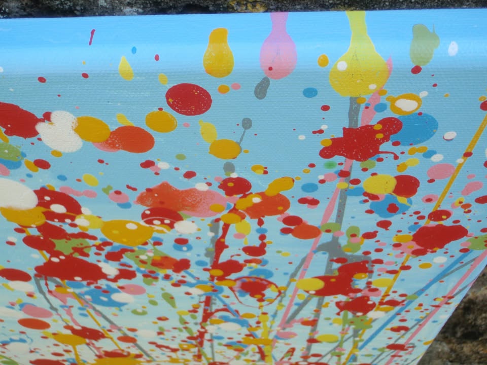 Colourful abstract painting of a wildflower meadow with green and yellow grasses, multi-coloured flowers, especially red flowers, and a light blue sky background - detail