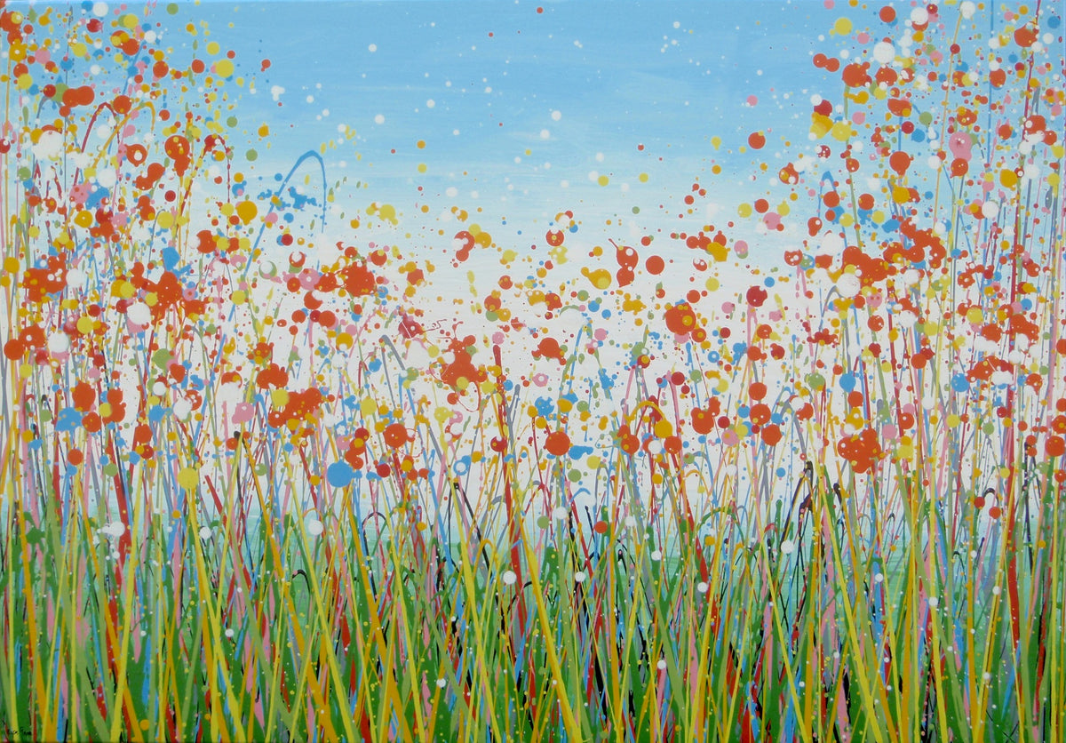 A colourful abstract painting of a grassy field with splattered flowers in orange, yellow, blue, and white against a light blue sky, hand-painted on to a large framed 100 by 70 cm canvas - full view