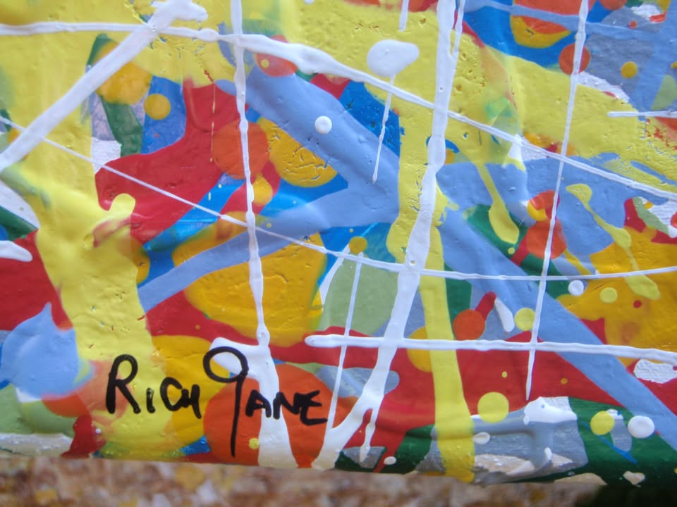 Abstract art with colourful drips and splashes of red, yellow, and blue, on a large framed canvas - detail