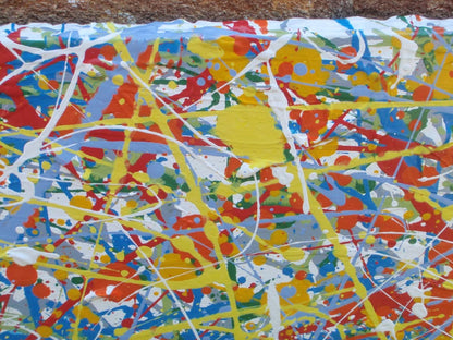 Abstract art with colourful drips and splashes of red, yellow, and blue, on a large framed canvas - detail
