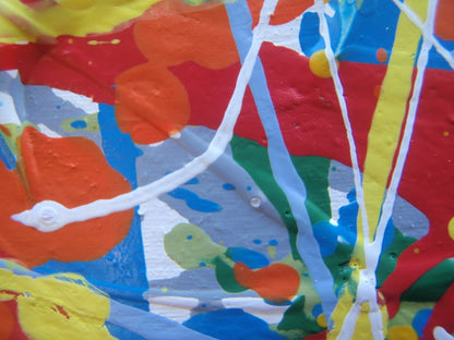 Abstract art with colourful drips and splashes of red, yellow, and blue, on a large framed canvas - detail