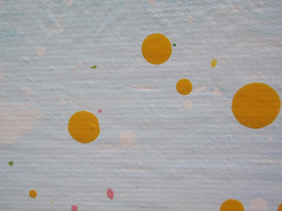 A colourful abstract painting of a grassy field under a blue sky, with splashes of pink, yellow, blue, green, and orange dots and lines throughout, hand-painted on to a large canvas - detail