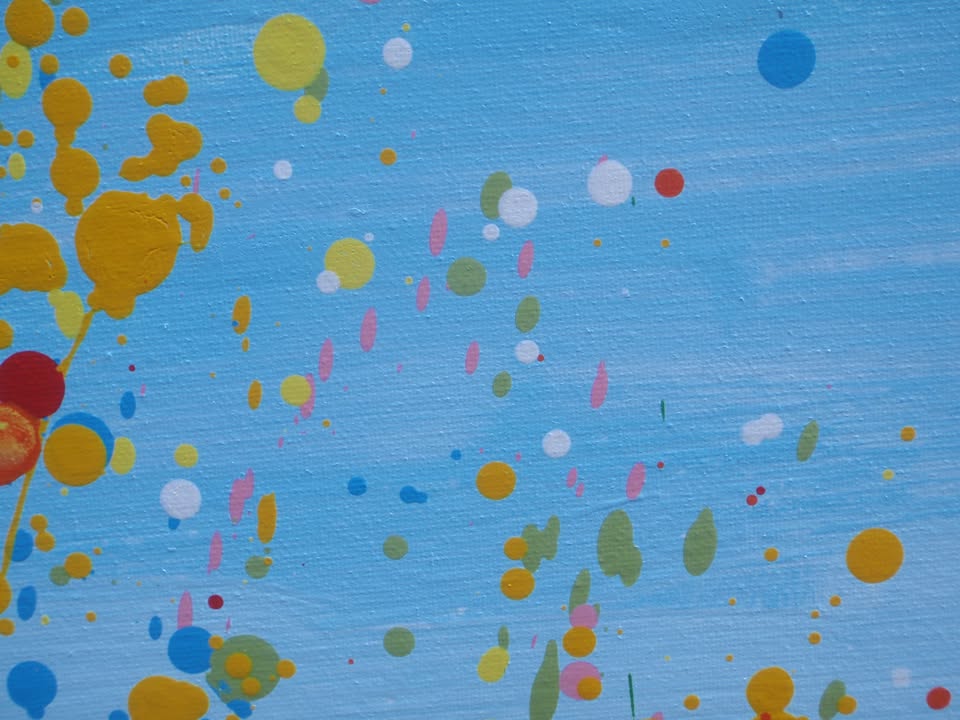 A colourful abstract landscape painting depicting a field of tall grass under a blue sky, with splatters and drips of yellow, red, orange, blue, pink, and green paint throughout. Hand-painted on to a large 101.5 by 81 cm stretched canvas - detail