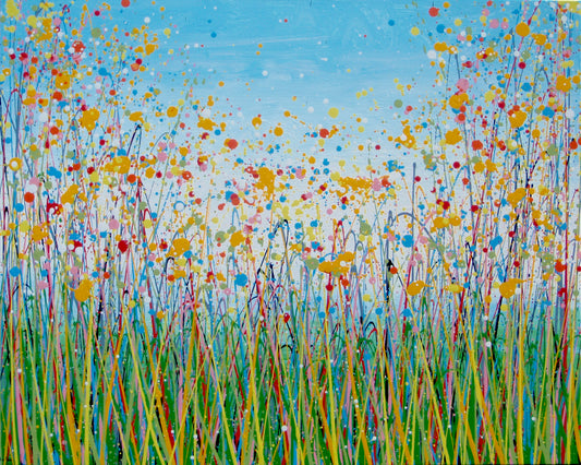 A colourful abstract landscape painting depicting a field of tall grass under a blue sky, with splatters and drips of yellow, red, orange, blue, pink, and green paint throughout. Hand-painted on to a large 101.5 by 81 cm stretched canvas - full view