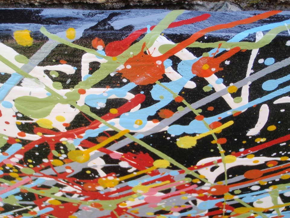 Really big hand painted colourful abstract painting on a very large framed canvas, featuring a vibrant starburst on a black background - detail
