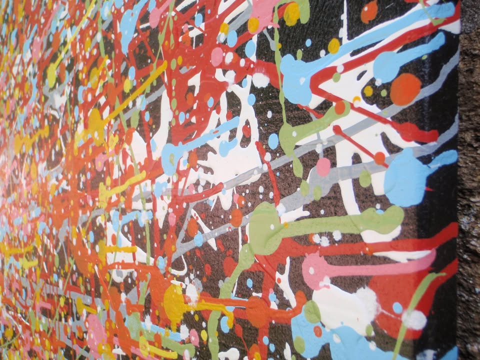 Really big hand painted colourful abstract painting on a very large framed canvas, featuring a vibrant starburst on a black background - detail