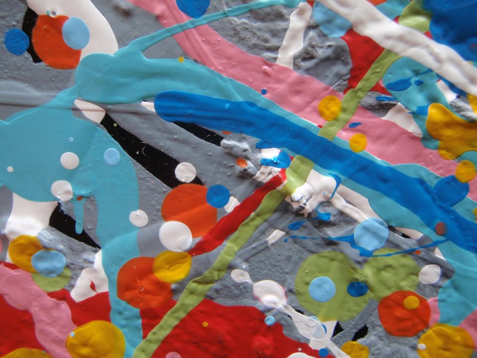 Unique abstract radial artwork filled with dense splatters and streaks of blue, red, orange, yellow, black, and white radiating from a bright white centre, on a 150 by 100 cm framed canvas - detail