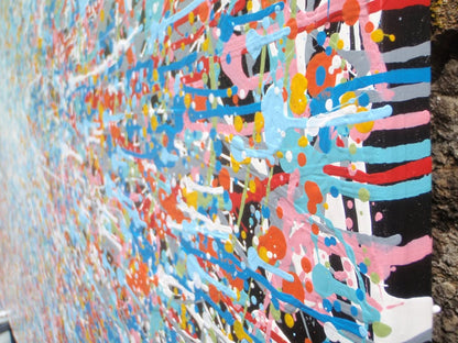 Unique abstract radial artwork filled with dense splatters and streaks of blue, red, orange, yellow, black, and white radiating from a bright white centre, on a 150 by 100 cm framed canvas - detail