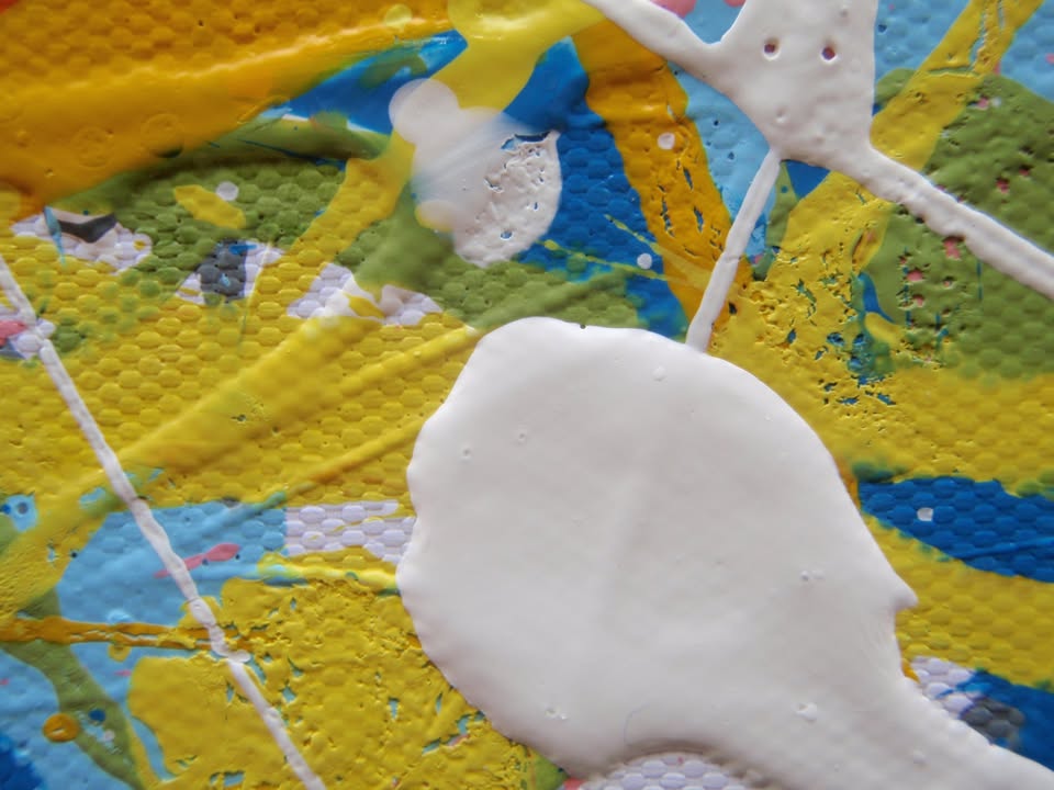 An abstract rectangular canvas painting filled with dense, energetic lines and dots in a multicolour palette of yellow, blue, orange, and white on a light background. Hand-painted on to a 250 by 112 cm canvas. Detail.