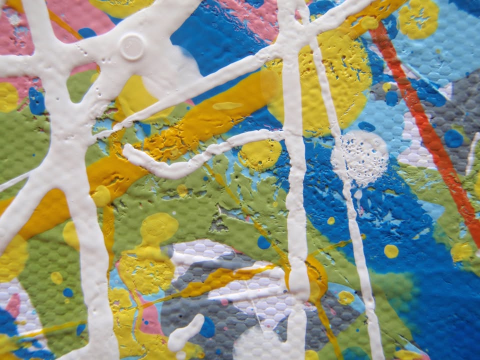 An abstract rectangular canvas painting filled with dense, energetic lines and dots in a multicolour palette of yellow, blue, orange, and white on a light background. Hand-painted on to a 250 by 112 cm canvas. Detail.