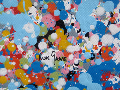 A rectangular abstract art painting featuring a dense seascape of multicoloured speckles, with a prominent horizontal band of white and light blue in the centre and denser blue speckling around the edges. Hand-painted on to a 250 by 112 cm un-stretched canvas. Detail.