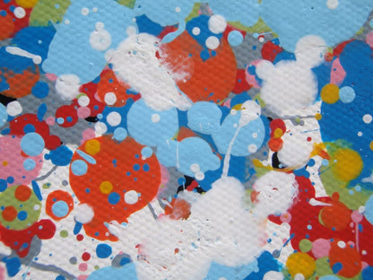 A rectangular abstract art painting featuring a dense seascape of multicoloured speckles, with a prominent horizontal band of white and light blue in the centre and denser blue speckling around the edges. Hand-painted on to a 250 by 112 cm un-stretched canvas. Detail.