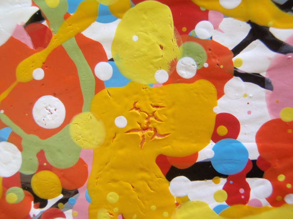 Abstract radial burst painting with dense splatters and streaks of yellow, orange, white, blue, pink, red, and green radiating outward from a bright central area, on 80 by 60 cm canvas - detail
