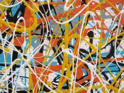 An abstract painting filled with dense, energetic splatters and drips in orange, yellow, white, black, and light blue, hand-painted on to a large framed wooden panel - detail