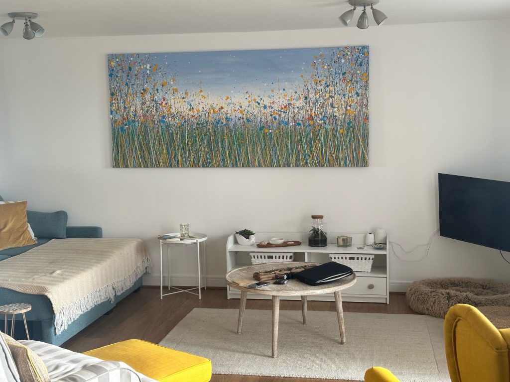 Customer showcase photo of my massive flower meadow painting on display in her property - closer view 1